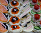 Gourmet Canapés with Salmon, Caviar, and Fresh Toppings - Image 2